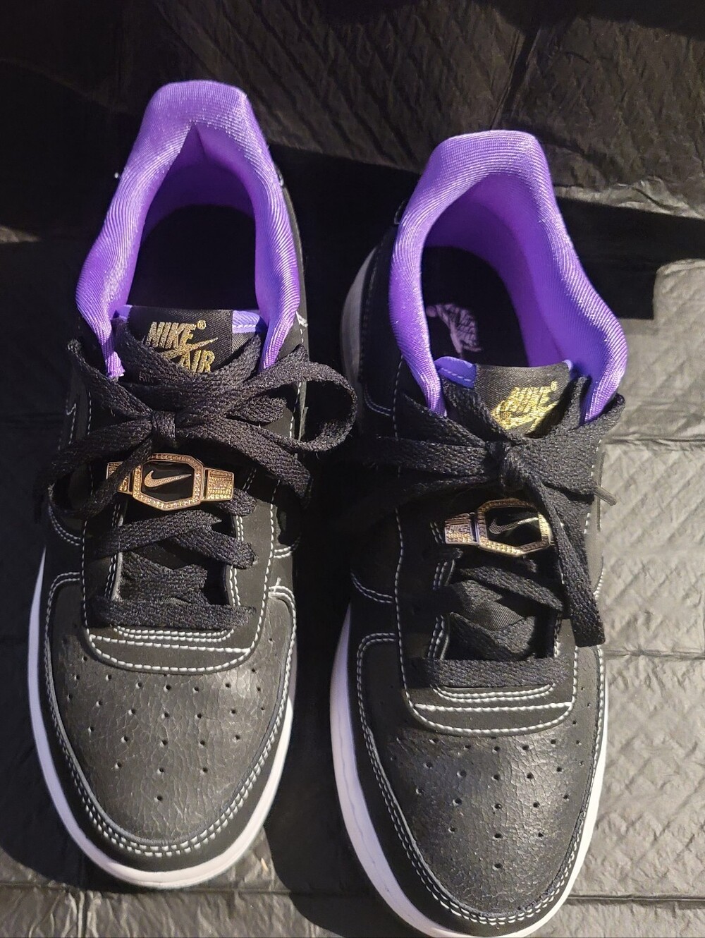 Nike Kids Black Sneakers with Purple Lining and Gold Logo